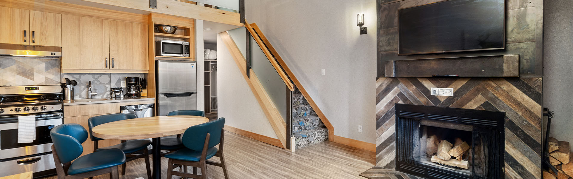 Living room with fireplace inside a One Bedroom plus Loft at Tunnel Mountain Resort in Banff.