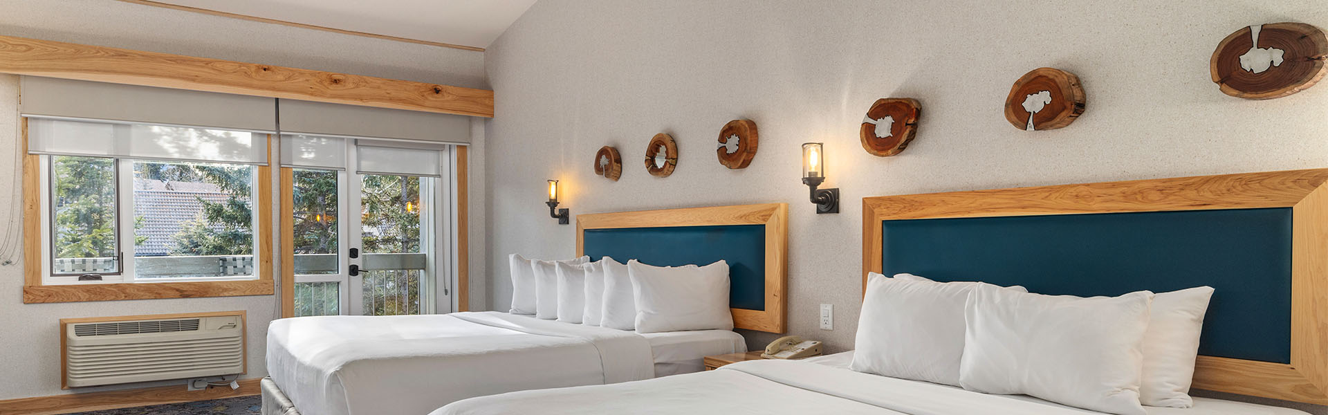 Bright and spacious superior guest room accommodation featuring scenic views at Tunnel Mountain Resort.