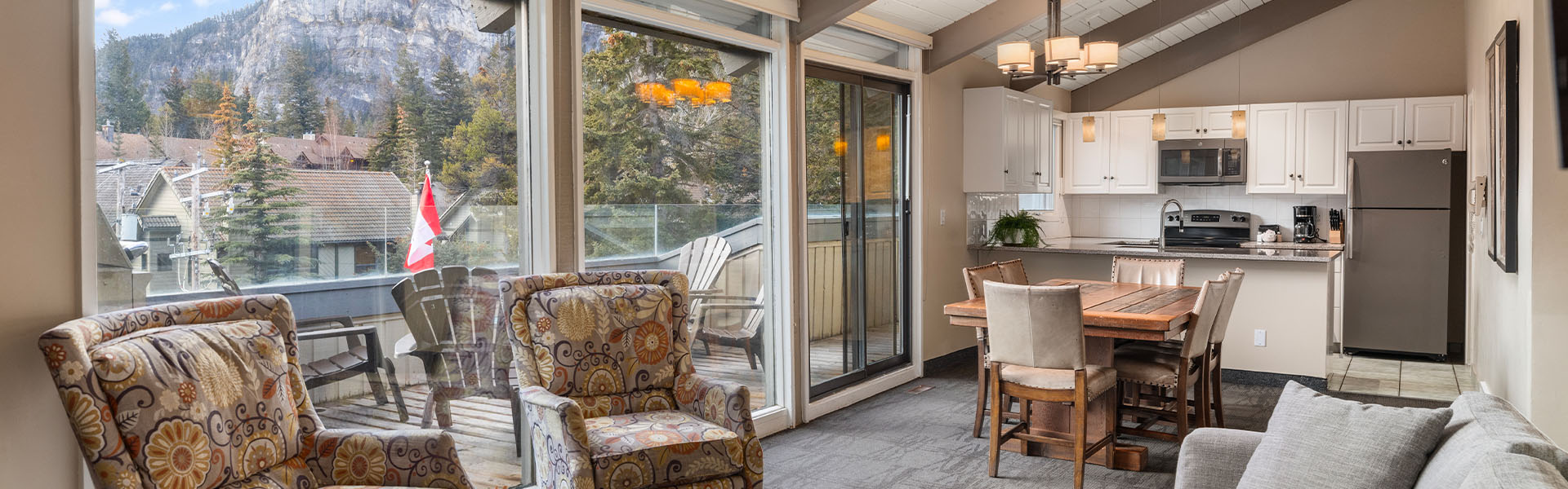 Living area with fireplace inside a Two Bedroom Suite with Kids Loft Area at Tunnel Mountain Resort.